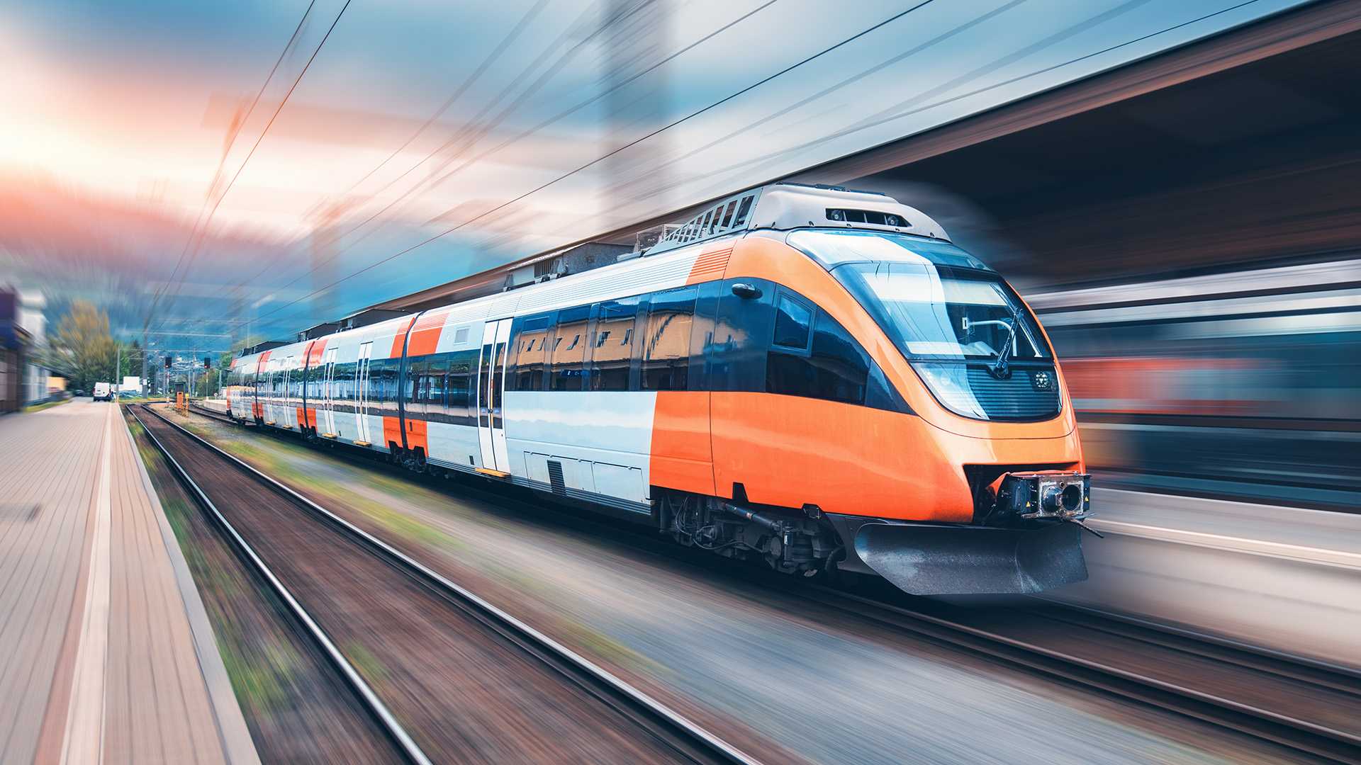 A train traveling at high speeds through a station.